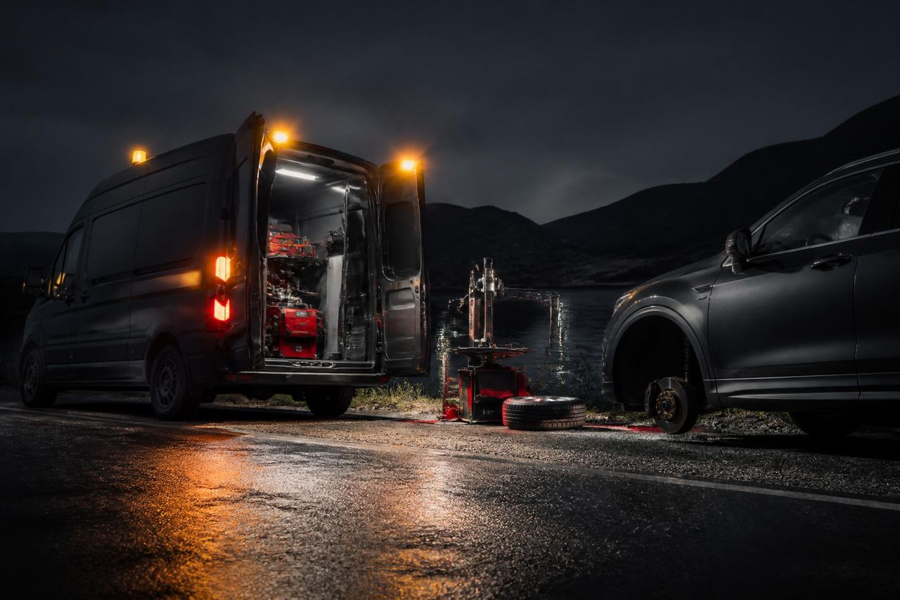 Go Pro Tires mobile tire service van with technician servicing a Ford SUV in the Okanagan